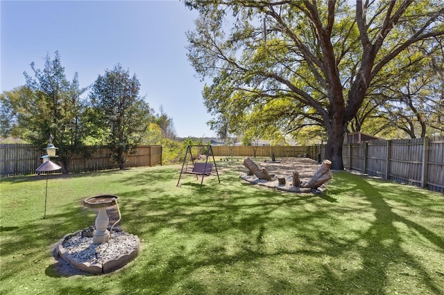 view of yard with an outdoor fire pit and a fenced backyard