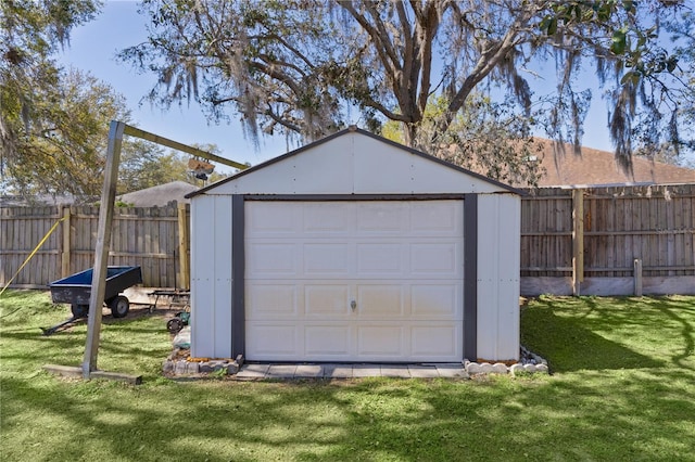 detached garage featuring fence