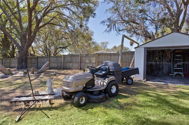 view of yard with a shed, an outdoor structure, and a fenced backyard