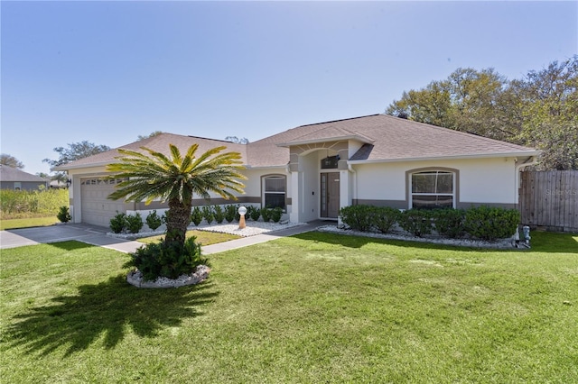 view of front of property with an attached garage, fence, driveway, stucco siding, and a front lawn