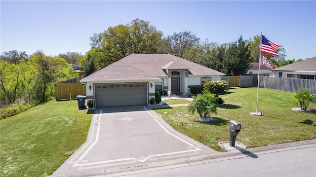 single story home featuring driveway, an attached garage, fence, and a front yard