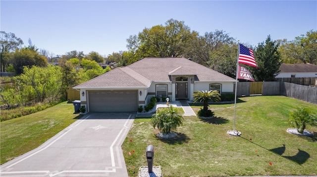 ranch-style home with an attached garage, fence, driveway, stucco siding, and a front yard