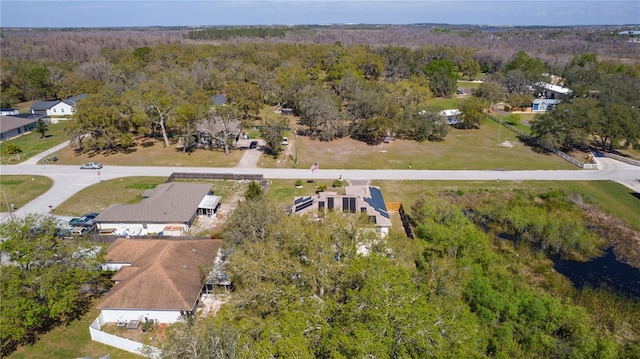 drone / aerial view featuring a wooded view