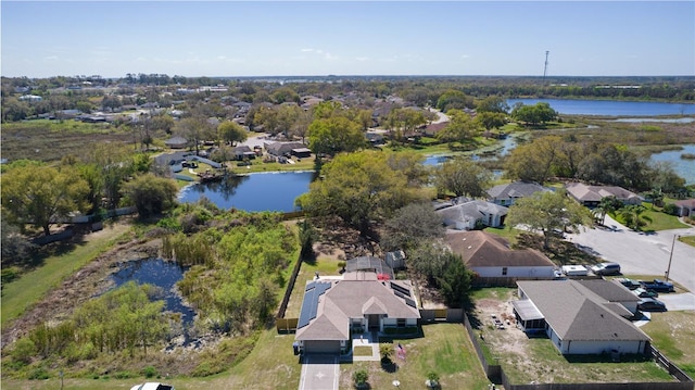 birds eye view of property featuring a water view and a residential view