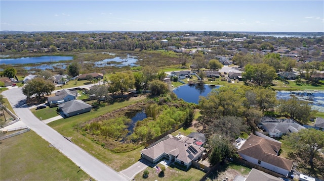 drone / aerial view with a water view and a residential view