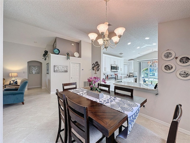 dining room featuring light tile patterned floors, arched walkways, an inviting chandelier, vaulted ceiling, and a textured ceiling