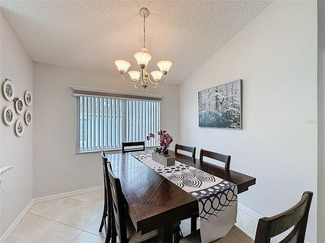 dining space featuring baseboards, lofted ceiling, a textured ceiling, a notable chandelier, and light tile patterned flooring