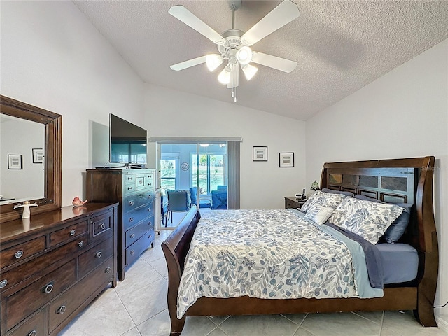 bedroom featuring access to exterior, lofted ceiling, light tile patterned flooring, and a textured ceiling