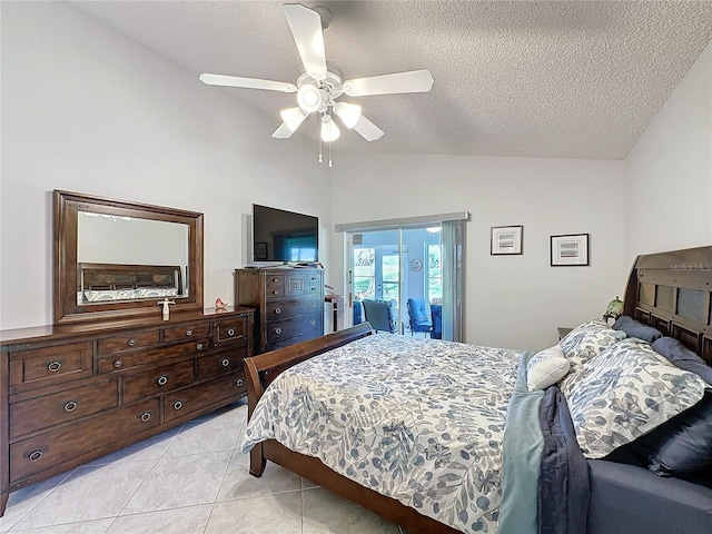 bedroom featuring light tile patterned floors, lofted ceiling, ceiling fan, access to outside, and a textured ceiling