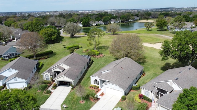 bird's eye view with golf course view, a water view, and a residential view