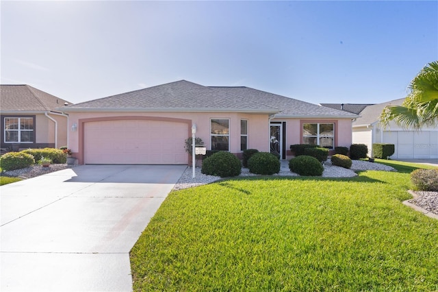 ranch-style home featuring concrete driveway, an attached garage, a front lawn, and stucco siding