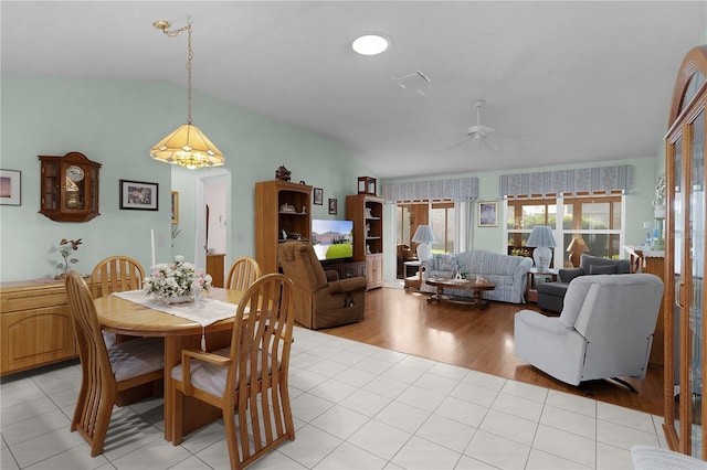 dining area featuring ceiling fan, visible vents, vaulted ceiling, and light tile patterned floors