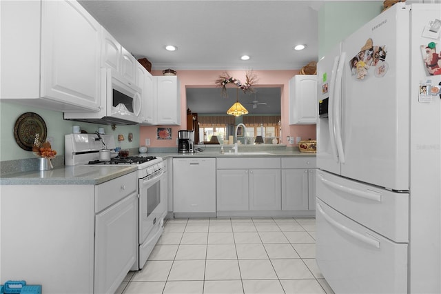 kitchen featuring white appliances, light tile patterned floors, white cabinetry, and a sink