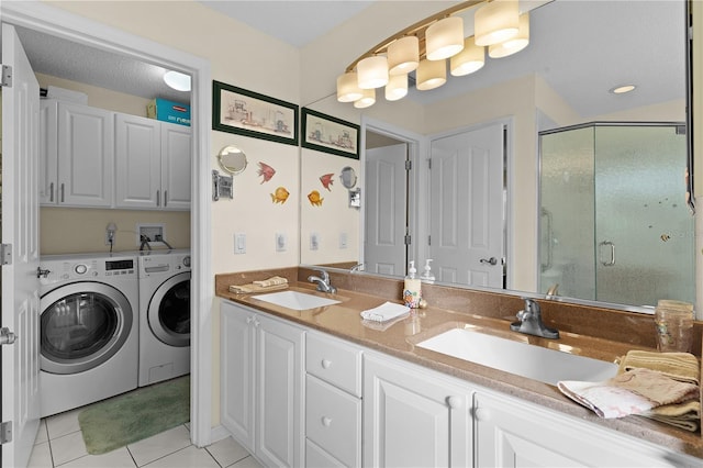 full bathroom with a shower stall, separate washer and dryer, a sink, and tile patterned floors