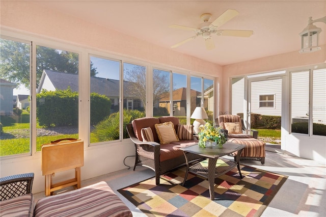 sunroom / solarium featuring a ceiling fan