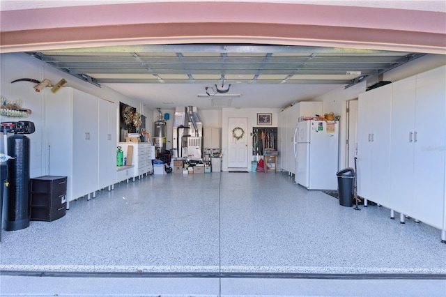 garage with freestanding refrigerator and gas water heater