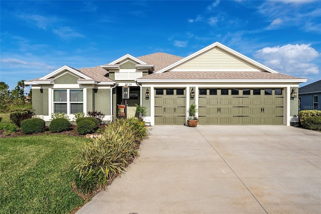 ranch-style home featuring a garage, driveway, roof with shingles, stucco siding, and a front lawn