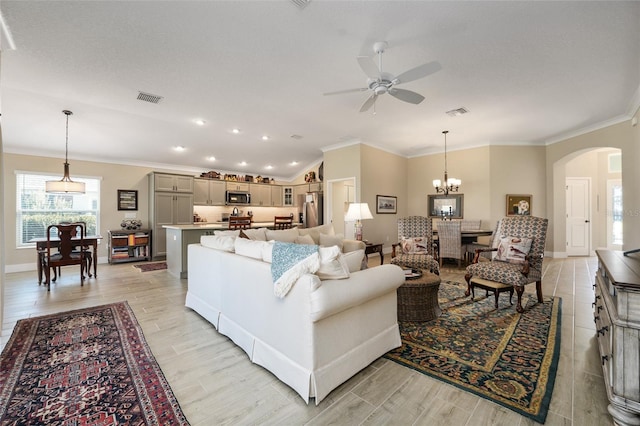 2124 Biller Cir, The Villages, FL 32163 - living area featuring visible vents, arched walkways, light wood-style flooring, and ornamental molding