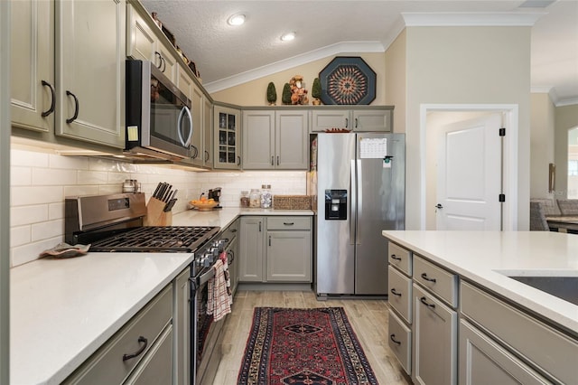 2124 Biller Cir, The Villages, FL 32163 - kitchen with crown molding, stainless steel appliances, and gray cabinetry