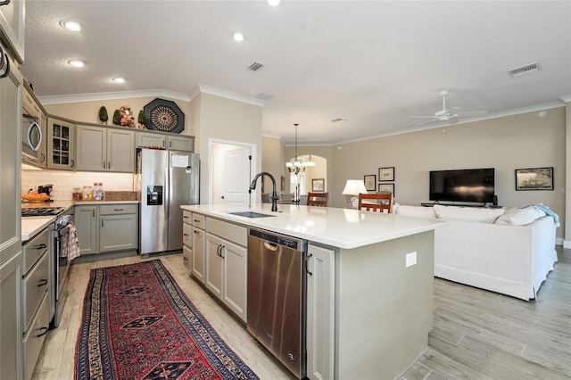 2124 Biller Cir, The Villages, FL 32163 - kitchen featuring an island with sink, appliances with stainless steel finishes, vaulted ceiling, gray cabinetry, and a sink