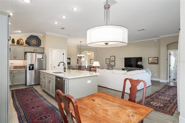 2124 Biller Cir, The Villages, FL 32163 - dining room with arched walkways, light wood finished floors, visible vents, and crown molding