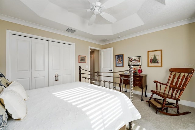 2124 Biller Cir, The Villages, FL 32163 - bedroom featuring a tray ceiling, a closet, carpet, and baseboards