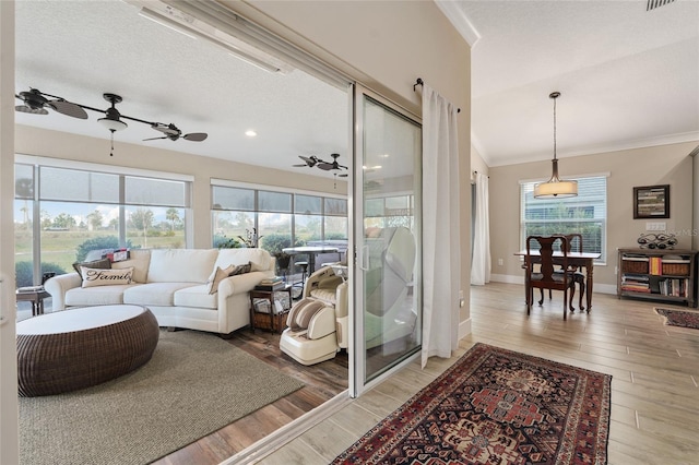 2124 Biller Cir, The Villages, FL 32163 - living room with ornamental molding, a ceiling fan, light wood-style flooring, and baseboards