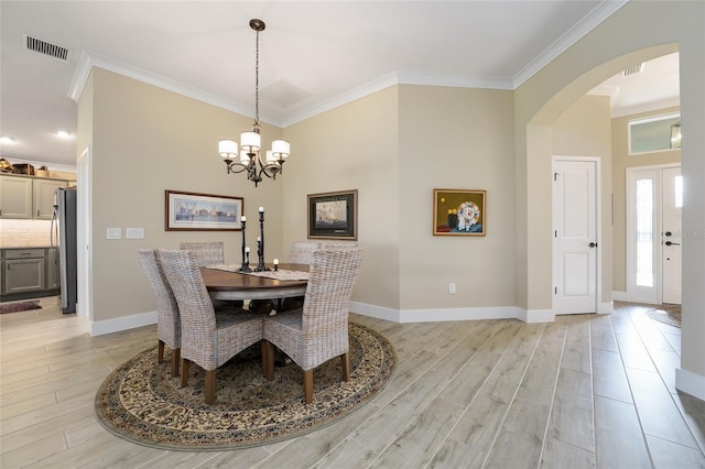 2124 Biller Cir, The Villages, FL 32163 - dining area featuring baseboards, light wood-type flooring, visible vents, and crown molding