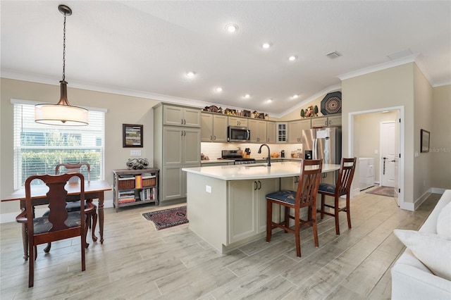 2124 Biller Cir, The Villages, FL 32163 - kitchen featuring lofted ceiling, ornamental molding, gray cabinets, stainless steel appliances, and light countertops