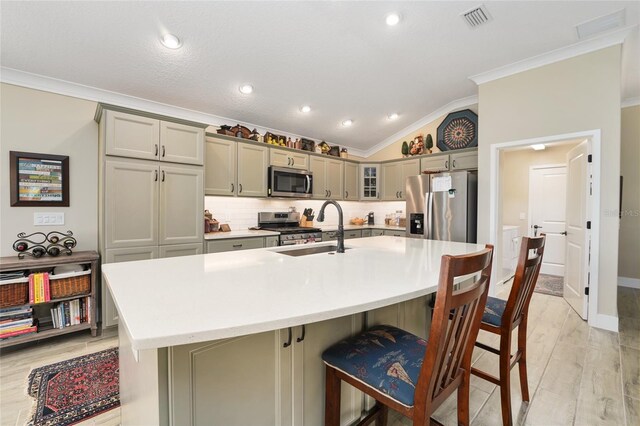 2124 Biller Cir, The Villages, FL 32163 - kitchen featuring stainless steel appliances, lofted ceiling, visible vents, gray cabinetry, and a sink