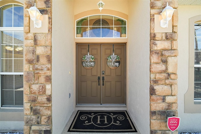 doorway to property featuring stucco siding