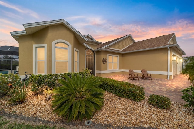 back of house featuring stucco siding