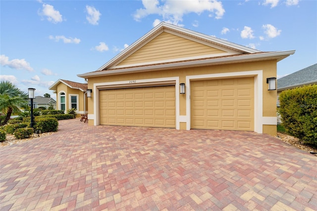 view of front of home featuring stucco siding and decorative driveway