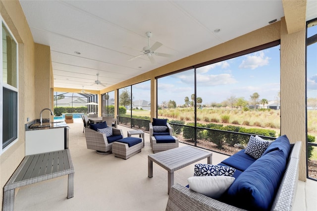 sunroom featuring a ceiling fan