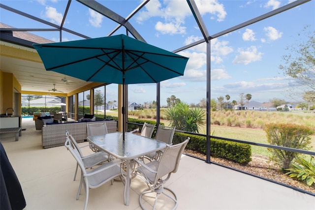 view of patio / terrace featuring an outdoor living space, a lanai, a ceiling fan, and outdoor dining space