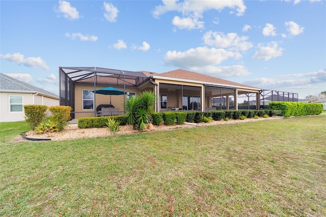 back of house with a yard, a patio, and glass enclosure