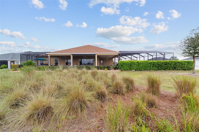 rear view of property featuring a lanai