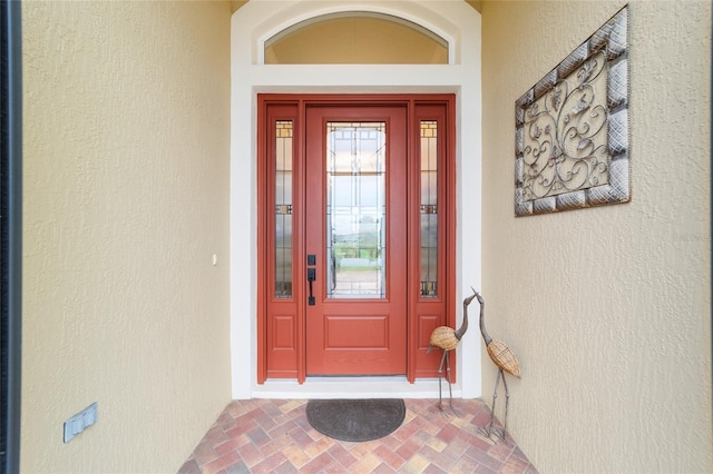 doorway to property with stucco siding