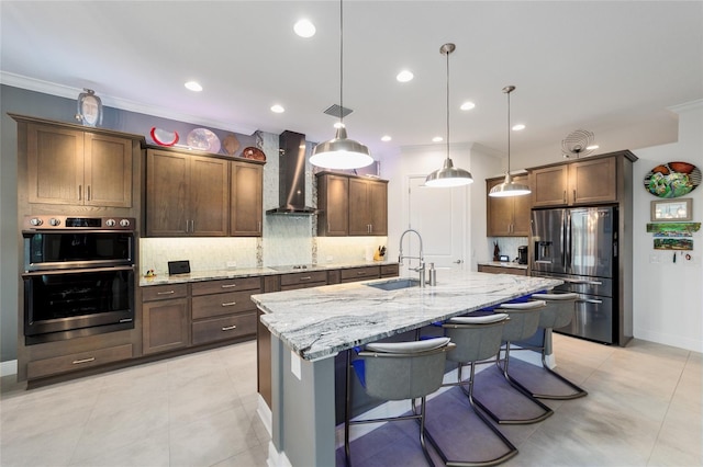 kitchen with backsplash, crown molding, appliances with stainless steel finishes, wall chimney exhaust hood, and a sink