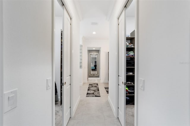 corridor with light tile patterned floors, baseboards, ornamental molding, and recessed lighting