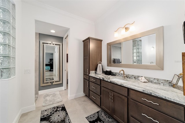 bathroom with vanity, baseboards, and ornamental molding