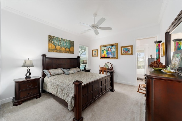 bedroom featuring ornamental molding, a ceiling fan, ensuite bath, baseboards, and light colored carpet