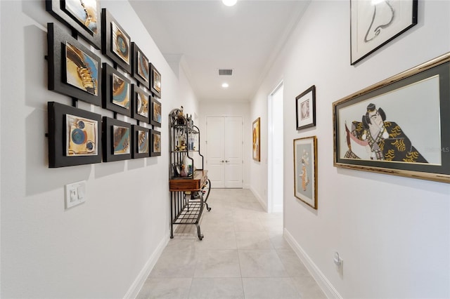 hall with light tile patterned floors, visible vents, baseboards, and recessed lighting