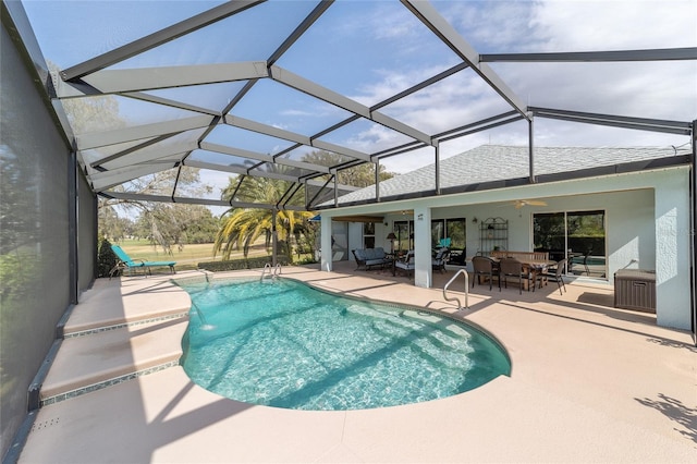 outdoor pool featuring a ceiling fan, a lanai, a patio, and an outdoor hangout area