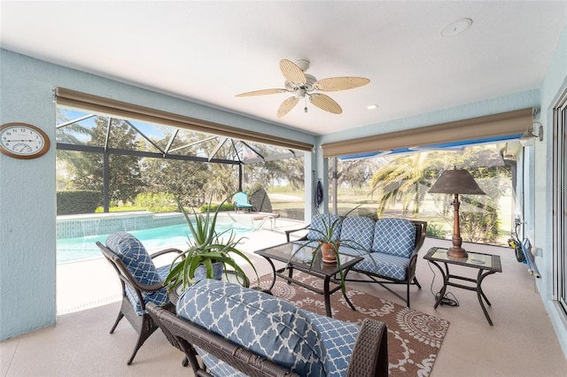 sunroom with a wealth of natural light and a ceiling fan