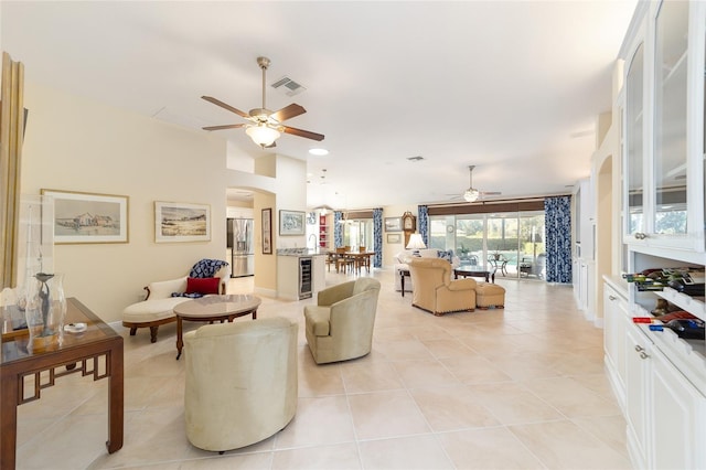 living area featuring beverage cooler, visible vents, arched walkways, ceiling fan, and light tile patterned flooring