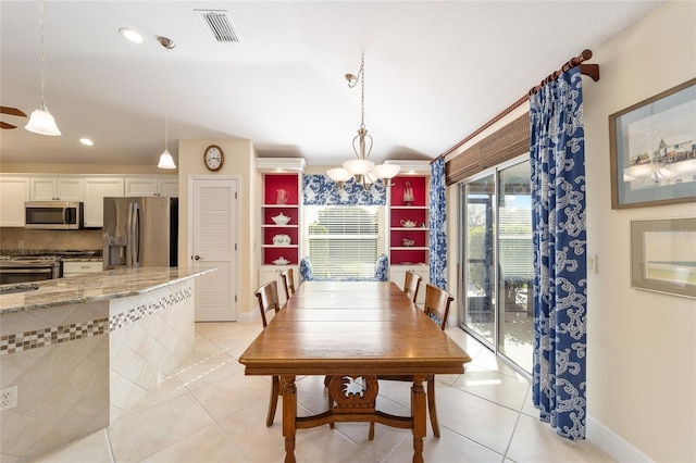 dining area featuring baseboards, visible vents, a notable chandelier, and light tile patterned flooring