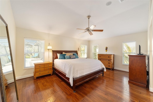 bedroom featuring dark wood-style floors, baseboards, and a ceiling fan