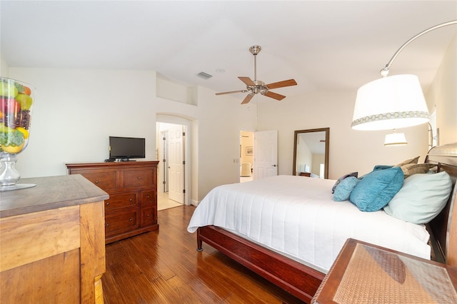 bedroom featuring lofted ceiling, dark wood-style flooring, visible vents, and ceiling fan