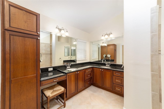 bathroom with double vanity, lofted ceiling, a sink, and tile patterned floors